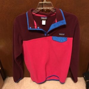 A maroon and light pink Patagonia pullover